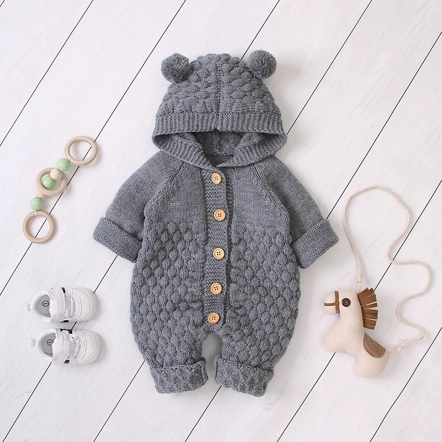 Ear Knit Romper With Hoodie Wrap Your Little One in Cozy Comfort with Our Ear Knit Romper HoodieImagine your baby wrapped in the softest knit fabric, snuggled up in a romper with an adorable hoodie. This piece is perfect for chilly days, ensuring your chi